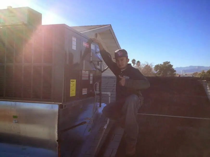 HVAC technician performing HVAC Inspection on a rooftop unit in Arden-Arcade